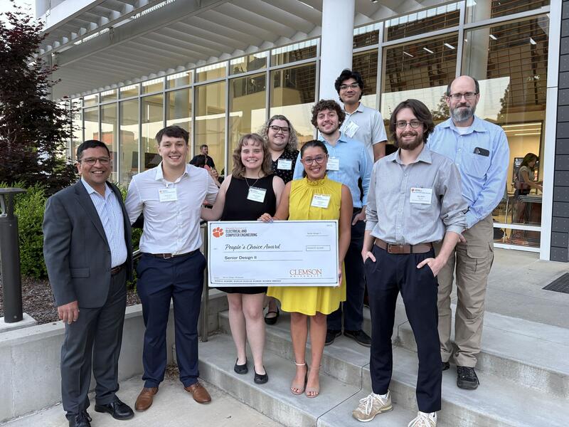 Drosophila senior-design team and faculty holding the People’s Choice recognition