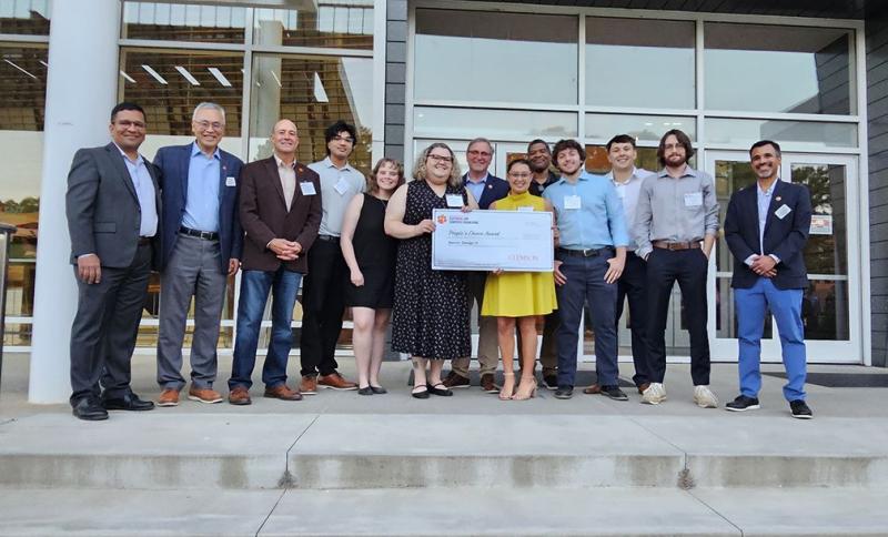 Drosophila senior-design team and advisers gathered outside after the showcase